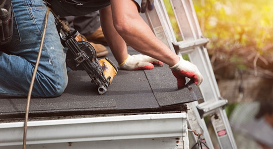 thumbnailfor worker on roof replacing shingles