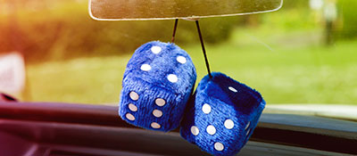 Blue fuzzy dice hanging from rearview mirror