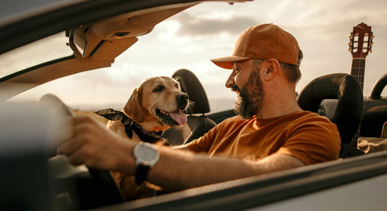 man in car with dog