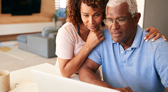 Elderly couple researching a Washington state mortgage refinance