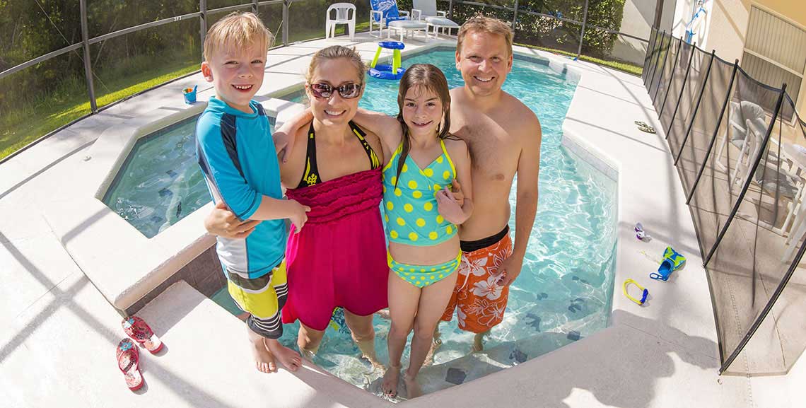 Family enjoying backyard pool at home
