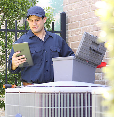 A technician works on an HVAC unit