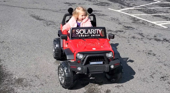 thumbnailfor Little girl riding in toy jeep