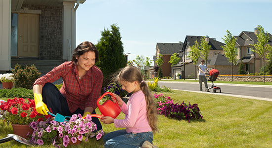 mom-and-daughter-planting-flowers-550x300