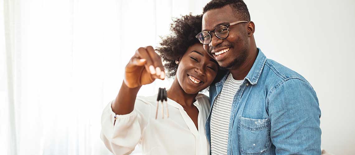 Young couple smiling after getting pre approval for mortgage