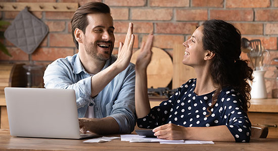 thumbnailfor Young couple refinancing their mortgage online from the kitchen