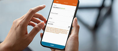 A woman uses the Solarity mobile app to schedule an automatic bill payment