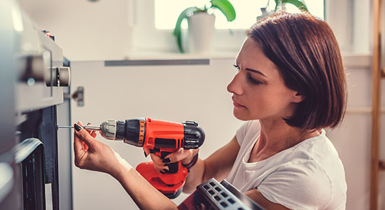 woman doing home repairs