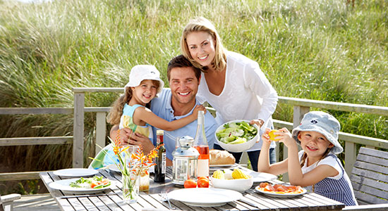 thumbnailfor Family having lunch outside new refinanced home through