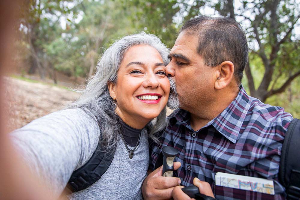 Man kissing his wife while hiking