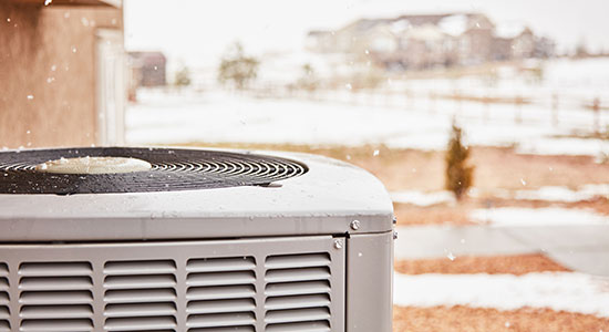 thumbnailfor An outdoor heat pump in a winter environment