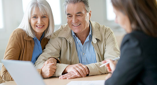 thumbnailfor Middle-aged couple speaking with a home loan guide