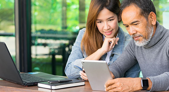 thumbnailfor Middle-aged couple sitting at computer comparing cash out refinance lenders