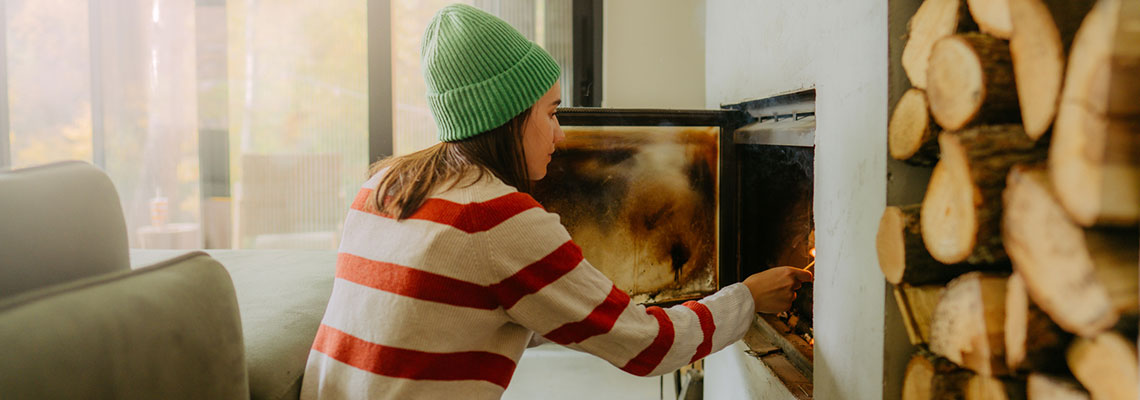 woman-adding-wood-to-fireplace-1140x400 woman-adding-wood-to-fireplace-1140x400