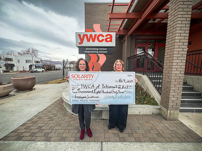 Solarity president Mina Worthington presenting a check to YWCA