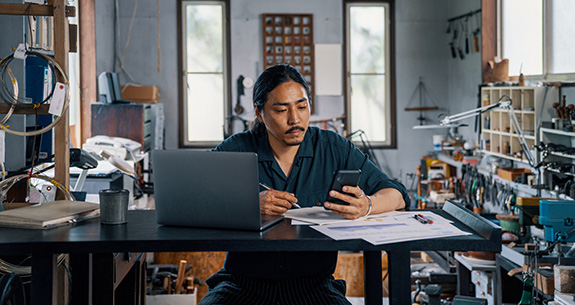 Small business owning utilizing merchant services in office
