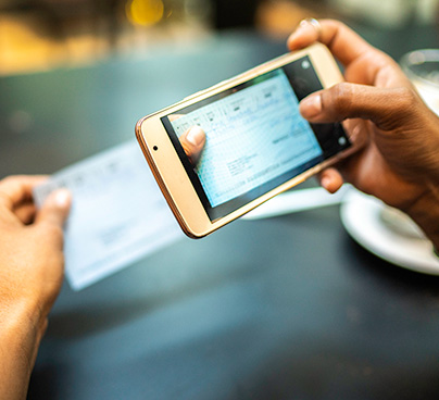 Person depositing check with mobile deposit