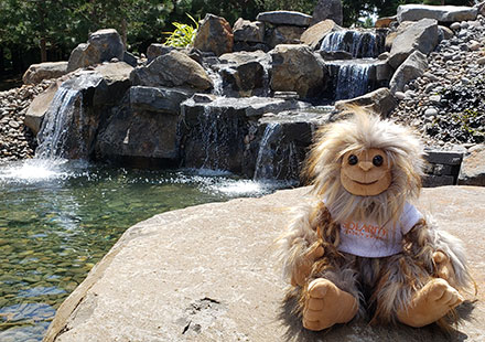 A Solarity Sasquatch hangs out by a waterfall
