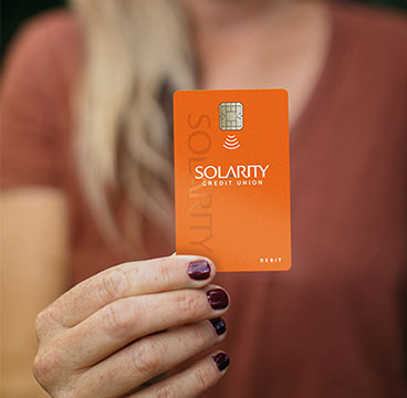 Woman holding Solarity Tap-to-Pay Credit Card