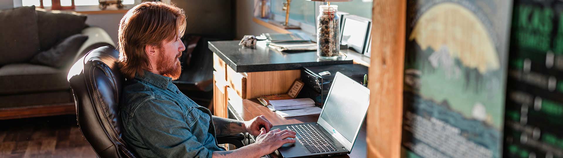 Man working on laptop in home office