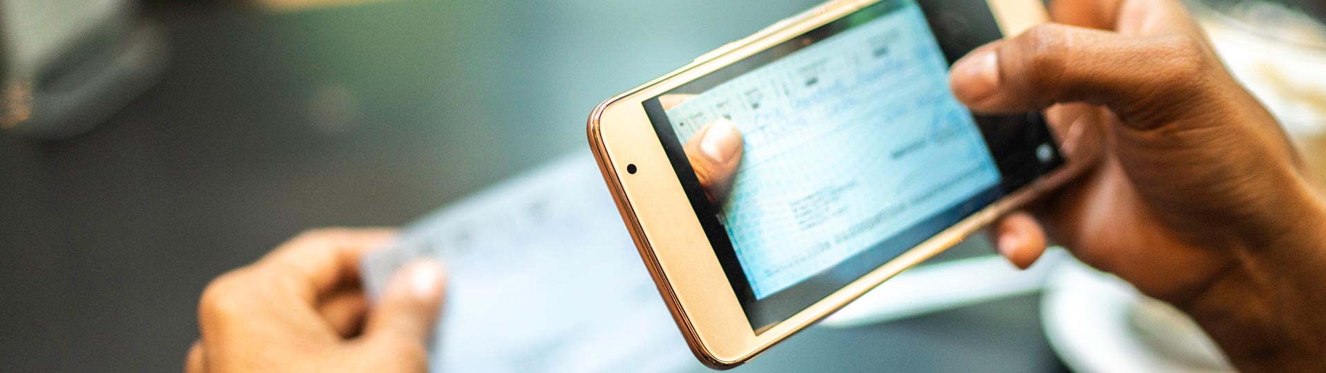 Person depositing check with mobile deposit