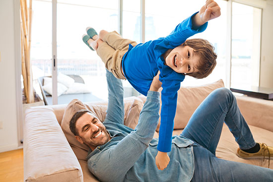 thumbnailfor Father with son on couch of new Home